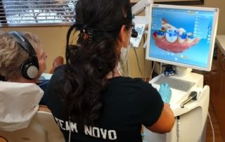 dentist designing crown on computer